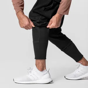Macro detail showing the rib-knit cuff of men's black slim-fit sports joggers