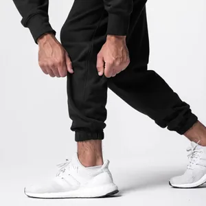 Detailed close-up of men's black cotton sports joggers showing the elastic cuff