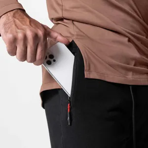 Close-up detail of men's athletic jogger zipper pocket showing smartphone storage