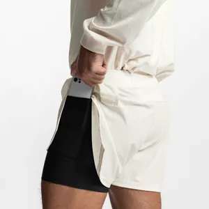 Macro detail of men's double-layer mesh training shorts showing hidden phone pocket.
