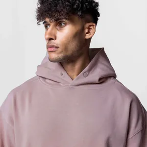 Close-up of mauve oversized hoodie with button neck detail for men's fitness style.