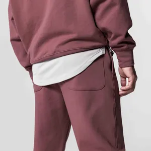 Back view of maroon oversized sweatpants and sweatshirt set with layered tee