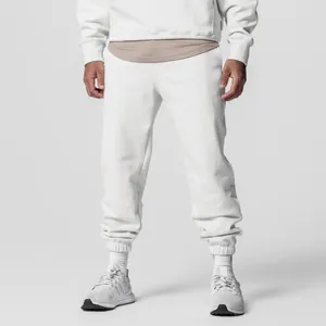 Close-up detail of men's loose white cotton sports joggers for a fitness sweatset