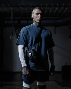 Professional view of oversized cotton sport t-shirt on model showing dark blue fabric texture
