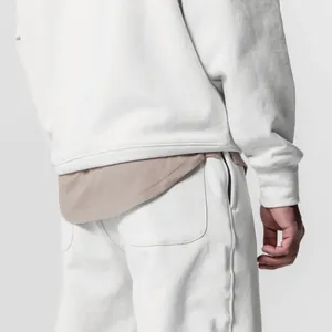 Detailed back view of men's white cotton athletic tracksuit with a layered hem design