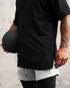 Detail view of oversized black athletic t-shirt with side slit and cotton fabric