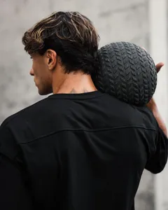 Detailed view of the back of a men's loose-fit black cotton sports t-shirt with model