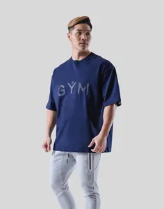 Oversized navy blue men's athletic t-shirt featuring GYM chest print on a male model