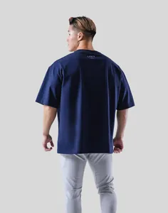 Back view of men's navy blue oversized fitness gym t-shirt with small logo detail.
