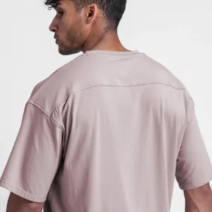 Close-up showing the back yoke detail of a men's oversized mauve cotton t-shirt