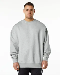Detail front view of a grey oversized fleece crewneck sweatshirt on a male model