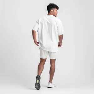 Back view of a premium loose white cotton sports t-shirt for men featuring stylish side slits