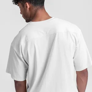 Back view detail of men's white oversized cotton sport T-shirt with seam stitching.