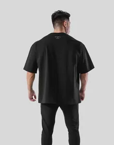 Professional back view of black oversized men's fitness t-shirt with rear neck logo detail.