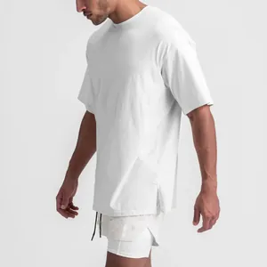 Detailed side view showing white oversized men's cotton sports t-shirt with side slit detail.