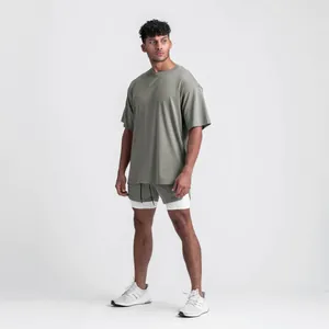Full view of male model wearing oversized olive green gym t-shirt with side slit