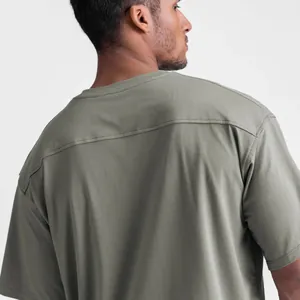 Detailed back view of olive green loose cotton sports T-shirt showing seam detail