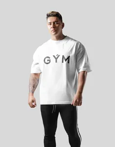 Professional fitness model wearing white oversized GYM t-shirt for bodybuilding