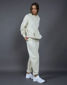 Professional studio shot of a cream 400G oversized fleece hoodie and joggers tracksuit set