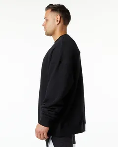 Side view profile of a heavy black oversized fleece sweatshirt featuring dropped shoulders