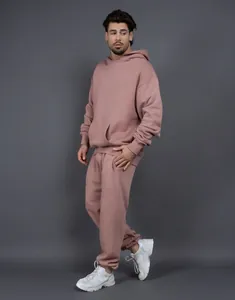 Heavyweight oversized dusty pink hoodie and sweatpants tracksuit set shown in professional studio shot
