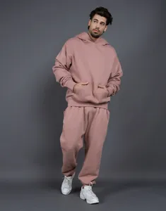 Close-up of the relaxed fit and soft texture of a mauve men's fleece tracksuit set