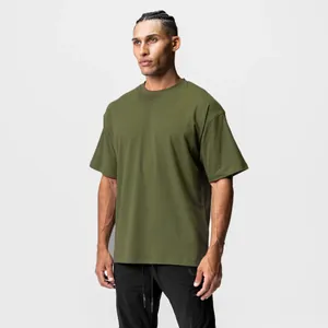 Model wearing an olive green oversized cotton t-shirt with a relaxed fit and round neck.
