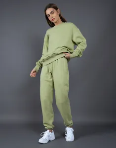 Vista completa de una modelo con un conjunto de sudadera y jogger oversize verde salvia.
