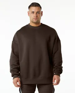 Front view detail of a dark brown oversized crewneck sweatshirt on a male model