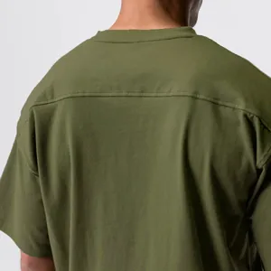 Close-up detail of the back shoulder stitching on an olive green cotton sports T-shirt
