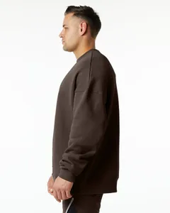 Side profile view of a heavy dark brown oversized crewneck sweatshirt for men
