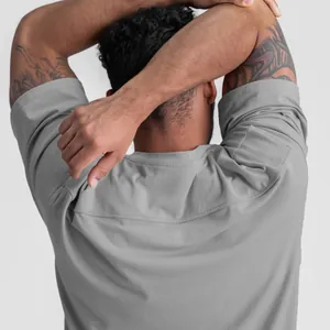 Detailed back view of men's loose gray cotton sports T-shirt showing fit and yoke seam