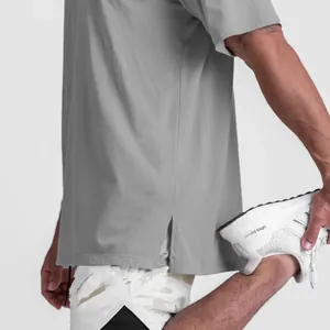 Close-up detail showing the side split hem on a grey men's loose fit cotton sports t-shirt