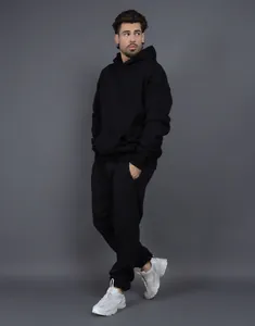 Full view of men's black oversized fleece hooded sweatshirt and jogger pants tracksuit set