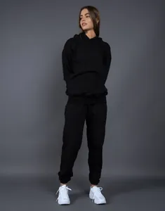 Front view of black oversized hooded tracksuit set on a model in a studio