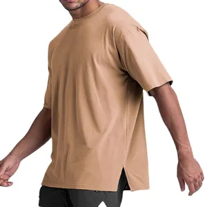 Side view detail of men's khaki oversized cotton t-shirt featuring split hem design