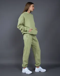 Profile view of oversized olive fleece-lined hoodie and joggers set for a cozy fit