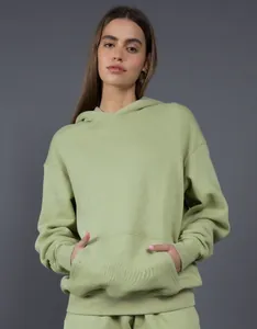 Detailed view of a premium oversized sage green hoodie with a front kangaroo pocket