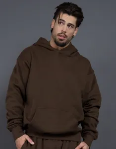 Close-up of heavy 400g fleece brown hoodie showing loose fit and premium fabric texture.