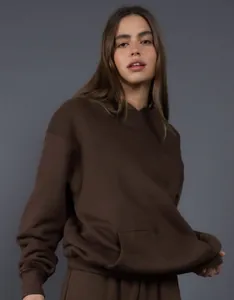 Close-up of oversized brown hoodie showing relaxed fit and soft fabric texture
