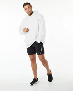 Caucasian male model wearing a heavyweight white oversized pullover hoodie with black shorts