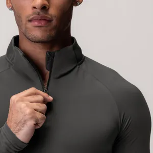 Close-up detail of half-zip collar on men's grey quick-dry compression top