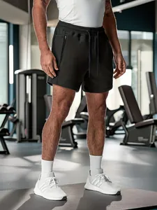 Detail of men's black cotton athletic shorts with zipper pockets and drawstring