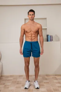 Vooraanzicht van heren blauwgroene sneldrogende sportshorts op een fitnessmodel in kamer