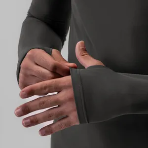 Close-up detail of thumbhole cuffs on a men's compression long sleeve dry-fit athletic shirt
