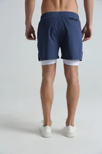 Back view of men's navy blue double-layer athletic shorts with white inner lining