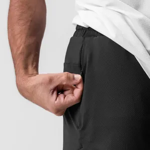 Detalle del bolsillo con cremallera oculta en el pantalón corto deportivo negro de hombre