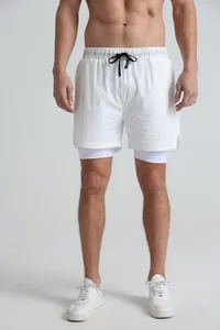 Full view of white double-layer men's sports shorts showing the liner and fit on a model