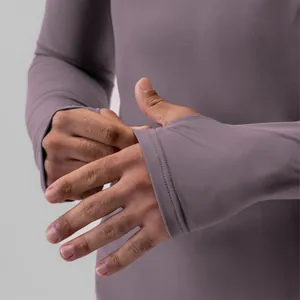 Detail view of mauve men's compression shirt sleeve featuring functional thumbholes