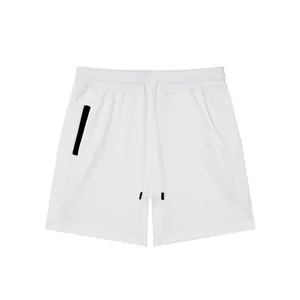 Detailed view of white breathable cotton sports shorts featuring a black zipper pocket